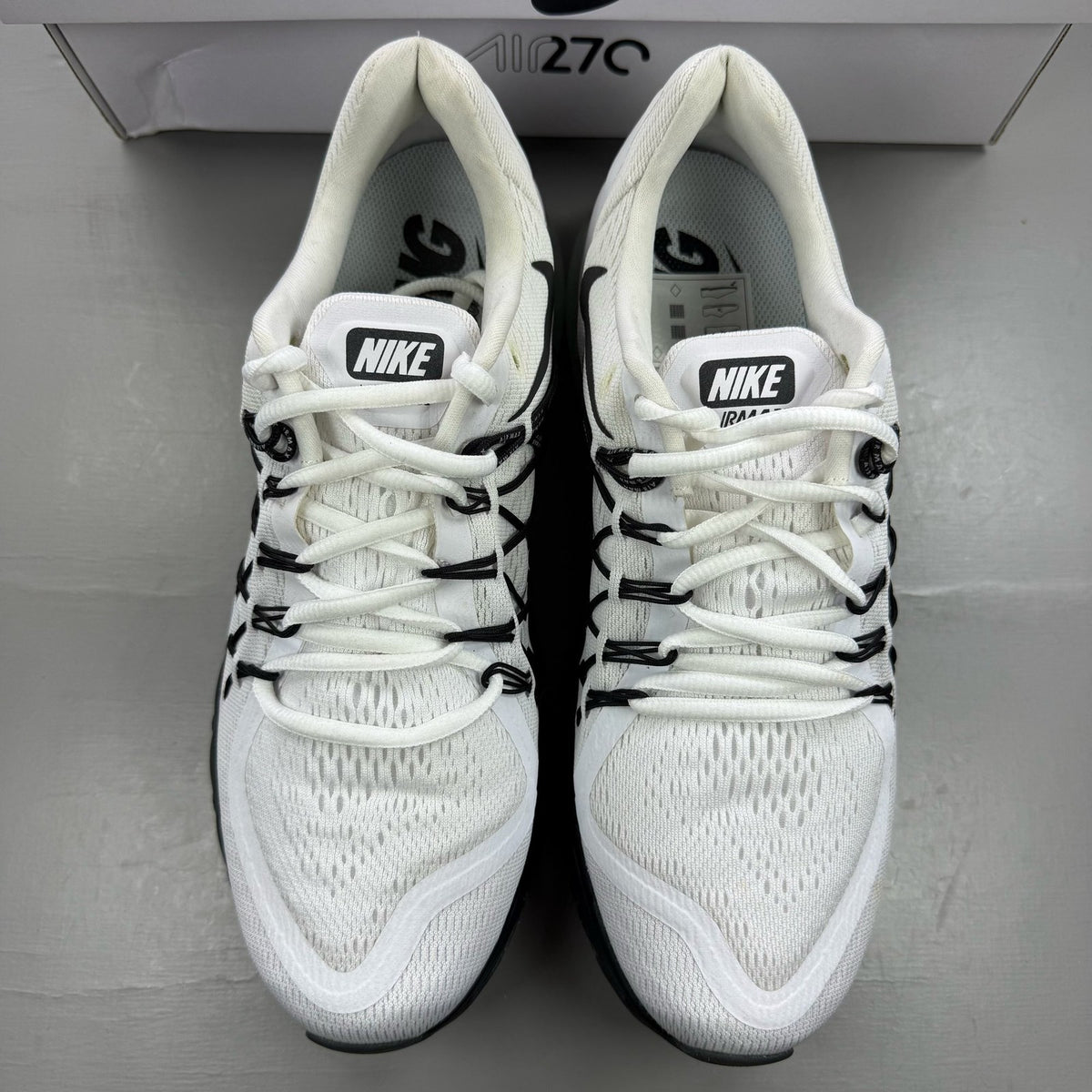 Nike Air Max 2015 white running shoes with black accents and logo detail.